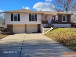 Exterior of 49-year-old raised ranch in Cherokee Estates subdivision of Blue Springs, MO — 64015 (38.9981N, 94.2827W)