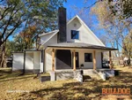 Exterior of vacant 105-year-old 2-story home in North Heights subdivision of Blue Springs, MO — 64015 (39.0246N, 94.2811W)