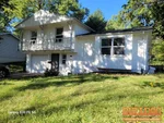 Exterior of 58-year-old raised ranch in Park Grove subdivision of Grandview, MO — 64030 (38.8807N, 94.5186W)