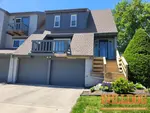 Exterior photo of 50-year-old vacant townhome inspected at 201 Woodbridge Ln, Kansas City, MO 64145 (38.8924N, 94.5922W)