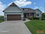 Exterior of 13-year-old reverse 1.5-story home in Raven Crest subdivision of Olathe, KS — 66061