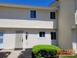 home-inspector-grandview-mo-6006-e-127th-st-64030-38.89446200N-94.52276080W-bulldog-home-inspections-04-29-2025 Exterior photo of 50-year-old vacant townhome inspected at 6006 E 127th St, Grandview, MO 64030 (38.8945N, 94.5228W)