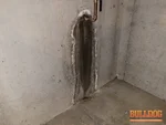 foundation-seepage-lone-jack-mo-14015-hutt-rd-64070-38.85959800N-94.19209010W-bulldog-home-inspections-20250630_115109 Active foundation seepage around water main valve uncovered during inspection of a 14-year-old ranch-style farmstead in the Robinson Estates subdivision of Lone Jack, MO (38.8596N, 94.1921W).
