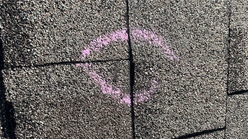 chalked hail damage hit to roof shingles