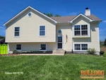 home-inspector-greenwood-mo-704-16th-ave-s-64034-38.84603480N-94.35432470W-bulldog-home-inspections-20250723_114147 Exterior of vacant 31-year-old split-level home at 704 16th Ave S, Greenwood, MO — 64034 (38.8460N, 94.3543W)