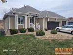 Exterior of 20-year-old reverse 1.5-story home in Eagle Glen subdivision of Raymore, MO — 64082 (38.8032N, 94.4763W)