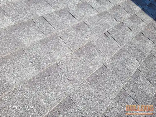 20-year-old-south-side-shingles-kansas-city-mo-2804-ne-parvin-rd-64117-39.16343860N-94.54669300W-bulldog-home-inspections-20251208_111429 20-year-old south side shingles showing deterioration - Brookwood, Kansas City, MO - December 2025