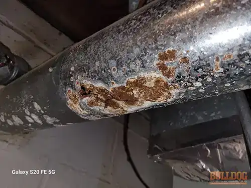 close-up-rusted-through-furnace-vent-grandview-mo-13609-cypress-ave-64030-38.87782100N-94.54096820W-bulldog-home-inspections-20251222_143521 Close-up rusted furnace vent - Stomp's John M, Grandview, MO - December 2025