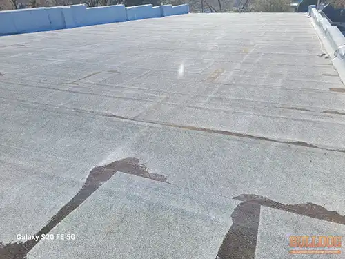 flat-roof-adrian-mo-145-e-main-st-64720-38.39721100N-94.35103750W-bulldog-home-inspections-20251205_112310 Flat roof with alligator cracking - Historic downtown Adrian, MO - December 2025 - 8-year-old rolled roof on 121-year-old building