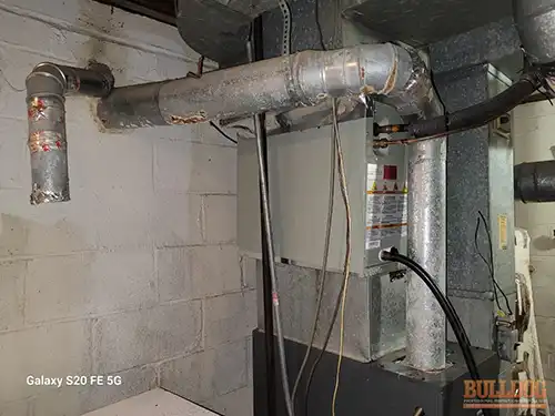 furnace-vent-entering-unlined-clay-flue-grandview-mo-13609-cypress-ave-64030-38.87782100N-94.54096820W-bulldog-home-inspections-20251222_143511 Furnace vent entering unlined clay flue - Stomp's John M, Grandview, MO - December 2025