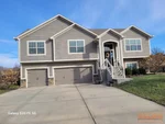 Exterior of 8-year-old split-level home in Eagle Glen subdivision of Raymore, MO — 64083 (38.8025N, 94.4778W)