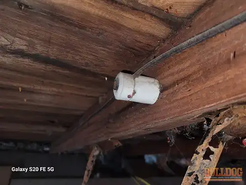 knob-n-tube-wiring-attic-st-joseph-mo-2908-charles-st-64501-39.76490330N-94.82162770W-bulldog-home-inspections-20251217_132104 Knob-n-tube wiring ceramic knob - Brookdale Addition, St. Joseph, MO - December 2025 - 105-year-old bungalow