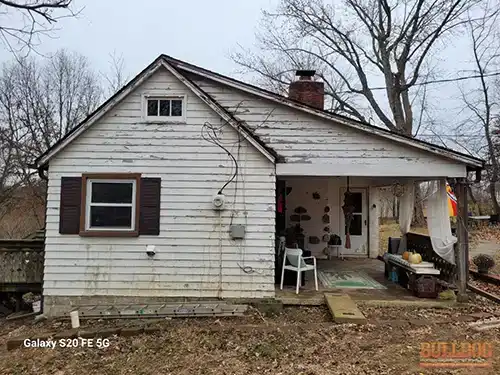 Loose service entrance cables pulled away from siding on Raytown, MO home showing failed mounting hardware and safety hazard
