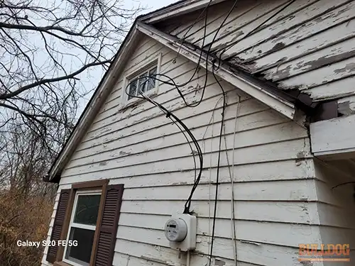 Loose electrical service entrance cables at Raytown home showing sagging conductors and compromised attachment