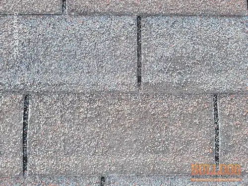 old-and-worn-roof-shingles-leavenworth-ks-726-730-osage-st-64083-39.32106860N-94.92077060W-bulldog-home-inspections-20251209_143048 Old worn asphalt shingles with granule loss - Leavenworth, KS - December 2025 - 48-year-old apartments