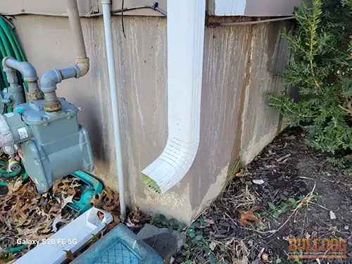 Water running down foundation corner - Southdowns subdivision, Olathe, KS - December 2025 - split-level home