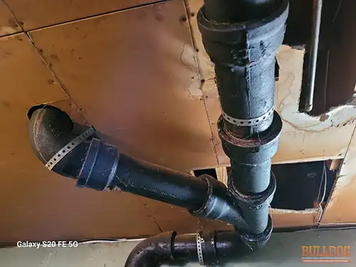 Cast iron sewer drain in basement ceiling, Bannister Slopes, Kansas City, MO – 64134 (38.94142880N, 94.50227060W)