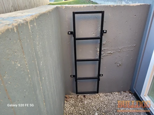 Window well ladder front view in Genesis Place at Green Hills, Kansas City, MO – 64154 (39.26752550N, 94.62590120W)