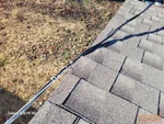 electrical-service-cables-rubbing-roof-shingles-close-up-grandview-city-mo-13620-bennington-ave-64030-38.87638920N-94.51675420W-bulldog-home-inspections-20251230_104703 Service cables rubbing roof shingles in Meadowmere subdivision of Grandview, MO – 64030 (38.8764N, 94.5168W)