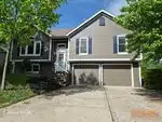 Exterior of 31-year-old split-level home in Woods Court subdivision of Smithville, MO — 64089