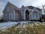 Exterior of 27-year-old 1.5-story home in Windsor Hills subdivision of Overland Park, KS – 66221 (38.8599N, 94.7015W)