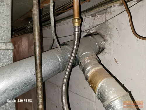 Image of furnace and water heater connected to clay flue in Nall Hills subdivision, Overland Park, KS. 66212