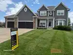 Exterior of 23-year-old 1.5-story home in Parkwood at Stoney Creek subdivision of Lee's Summit, MO — 64082