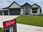 Exterior of new-construction reverse ranch home in Prairie Canyon subdivision of Olathe, KS — 66061