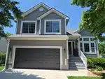 Exterior of 28-year-old split-level home in Windsor Trace subdivision of Olathe, KS — 66061