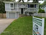 Exterior of 40-year-old split-level home in Hardman's Resurvey subdivision of Merriam, KS — 66203